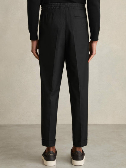 Relaxed-Fit Pleated Tapered Trousers in Black Men | Reiss